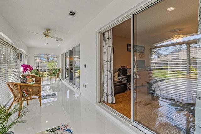 sunroom / solarium featuring visible vents and a ceiling fan