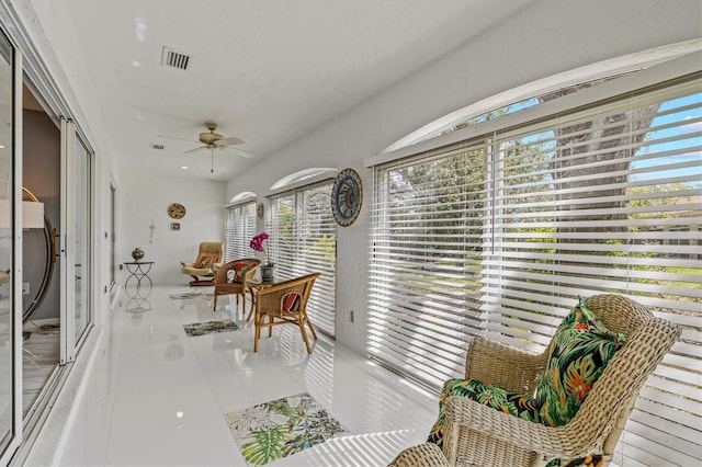 sunroom with visible vents and a ceiling fan