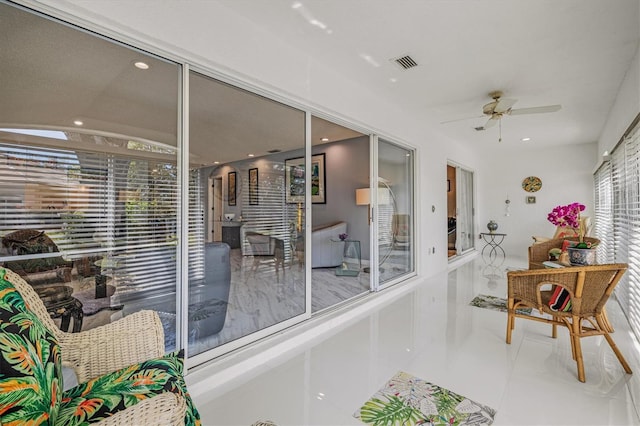 sunroom featuring ceiling fan and visible vents