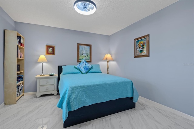 bedroom featuring a textured ceiling and baseboards