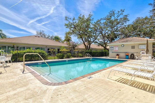 pool featuring a patio area and fence