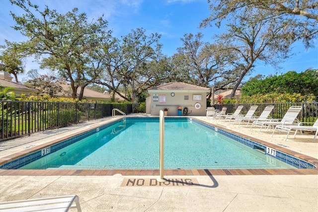 community pool featuring a patio area and fence