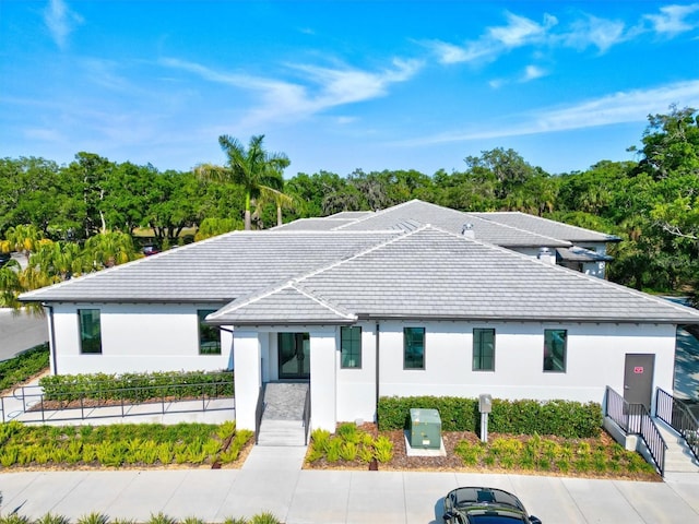 view of front of home featuring a tile roof and stucco siding