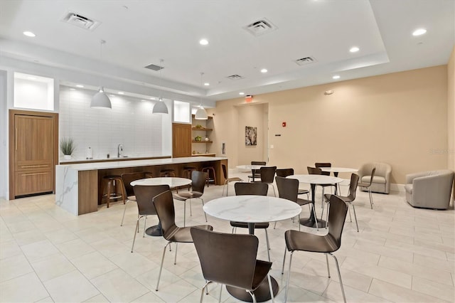 dining area featuring visible vents, a tray ceiling, and recessed lighting