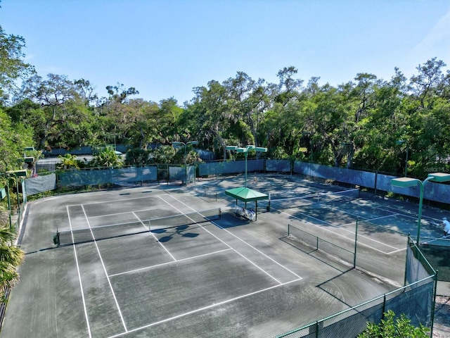 view of sport court featuring fence