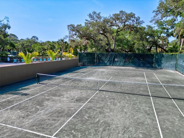 view of tennis court with fence