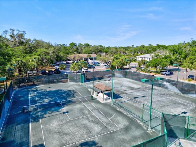 view of sport court featuring fence