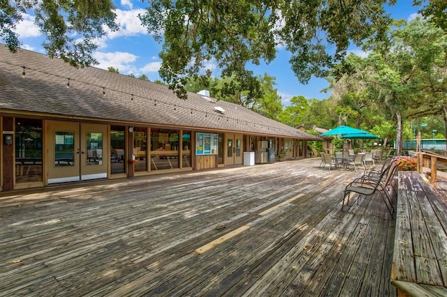 wooden deck featuring french doors and outdoor dining space