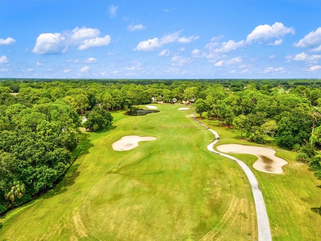 birds eye view of property with golf course view and a view of trees