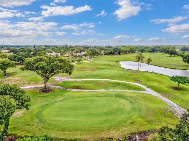 view of property's community with golf course view and a water view