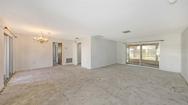 spare room with a notable chandelier