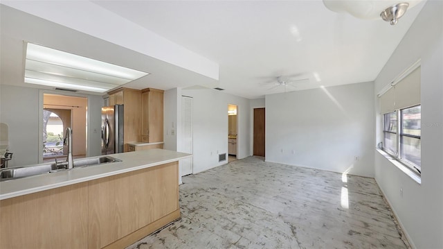 kitchen with sink, ceiling fan, stainless steel fridge, and plenty of natural light