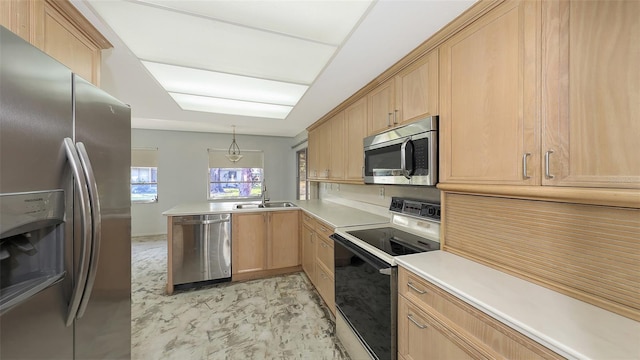 kitchen with kitchen peninsula, hanging light fixtures, stainless steel appliances, sink, and light brown cabinets