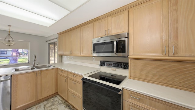 kitchen featuring sink, appliances with stainless steel finishes, light brown cabinetry, and pendant lighting