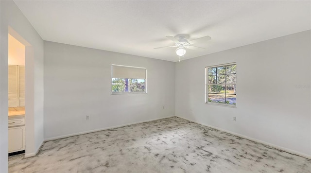 empty room with ceiling fan and a healthy amount of sunlight