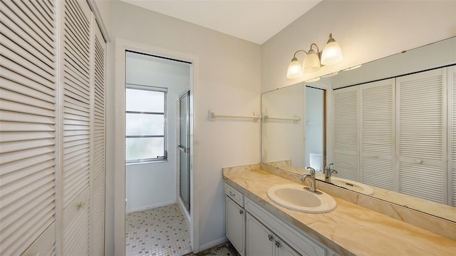 bathroom featuring vanity and an enclosed shower