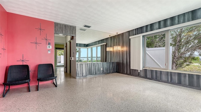 interior space with speckled floor and visible vents