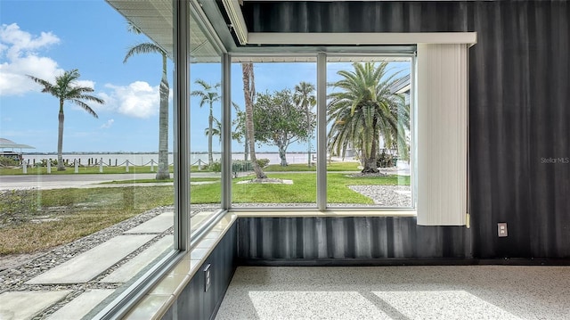 unfurnished sunroom featuring a water view and a healthy amount of sunlight