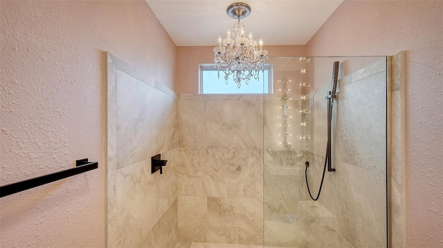 full bathroom featuring walk in shower, a notable chandelier, and a textured wall