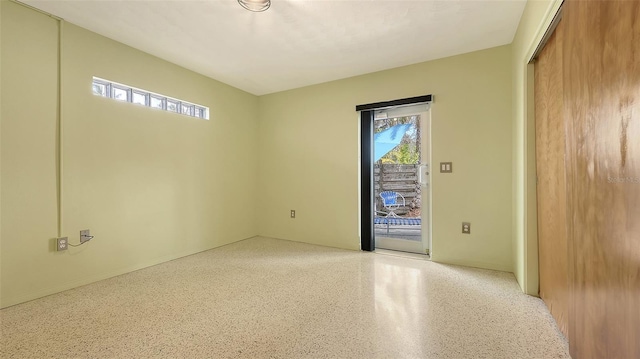 unfurnished room featuring light speckled floor