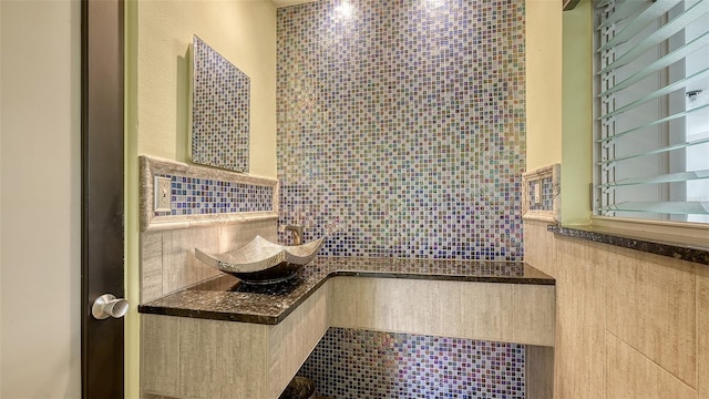 bathroom featuring wainscoting and tile walls