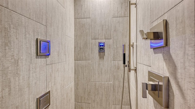 interior details featuring tiled shower