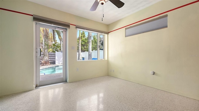 spare room featuring speckled floor and a ceiling fan