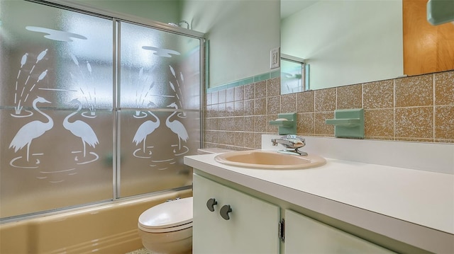 bathroom with toilet, bath / shower combo with glass door, backsplash, and vanity