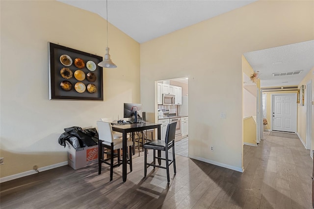 dining room with vaulted ceiling, dark wood-style flooring, visible vents, and baseboards