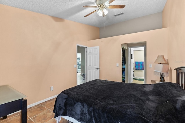 bedroom featuring visible vents, ceiling fan, a textured ceiling, and baseboards