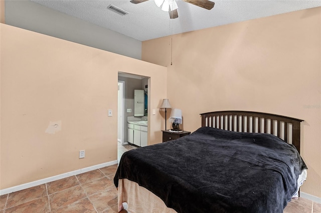 bedroom featuring baseboards, visible vents, connected bathroom, ceiling fan, and a textured ceiling