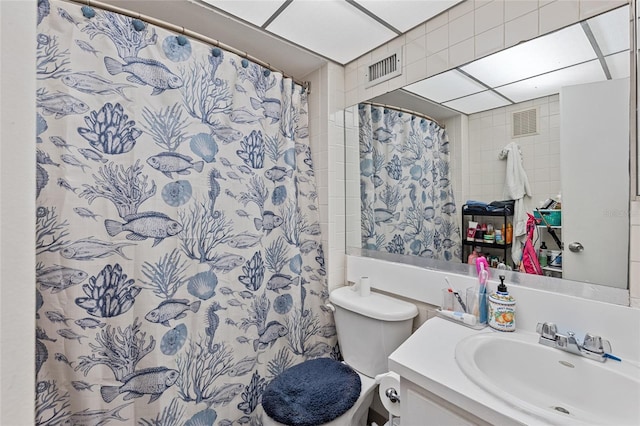 bathroom with visible vents, curtained shower, vanity, and toilet