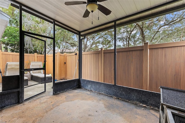 unfurnished sunroom featuring a ceiling fan