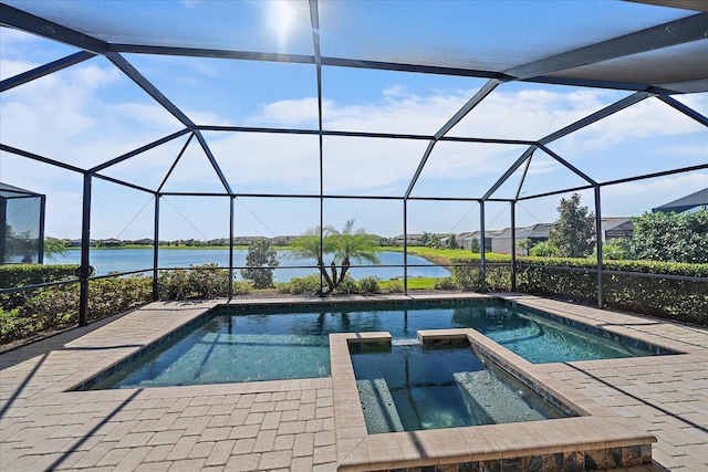 view of swimming pool with an in ground hot tub, glass enclosure, a patio, and a water view