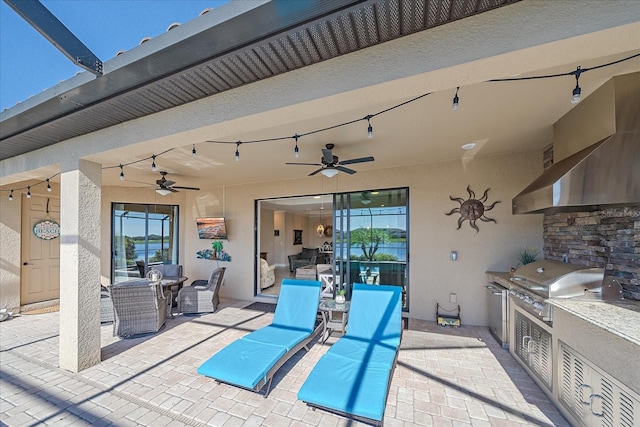 view of patio / terrace featuring ceiling fan, exterior kitchen, and grilling area