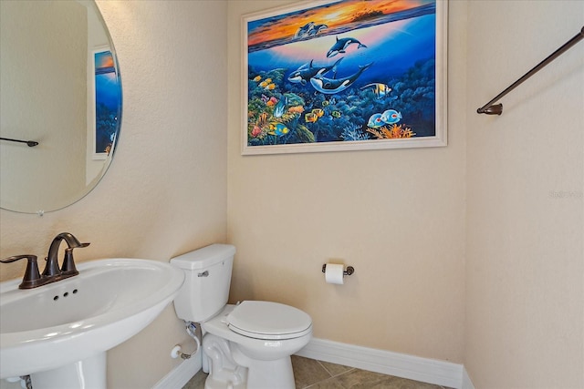 bathroom featuring sink, tile patterned flooring, and toilet