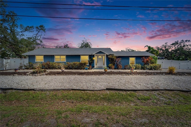 view of front of home featuring fence