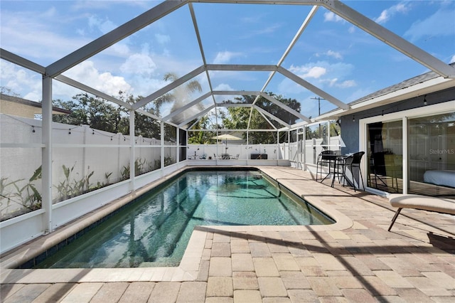 view of swimming pool with a fenced backyard, a patio area, a lanai, and a fenced in pool