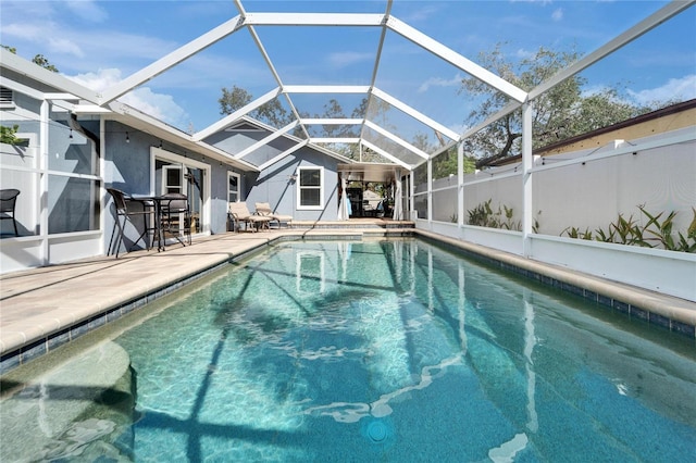 view of pool featuring glass enclosure, a patio area, and a fenced in pool