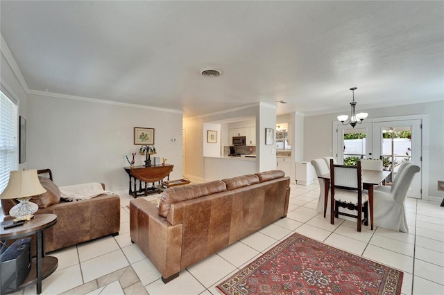 living area with visible vents, a chandelier, crown molding, and light tile patterned flooring