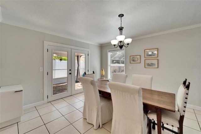 dining room featuring ornamental molding, french doors, a notable chandelier, and light tile patterned floors