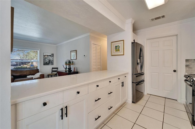 kitchen featuring crown molding, stainless steel refrigerator with ice dispenser, visible vents, light countertops, and white cabinetry