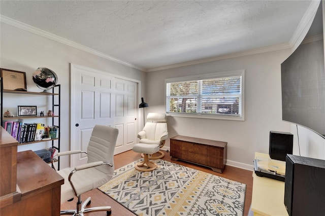 office space featuring crown molding, a textured ceiling, baseboards, and wood finished floors