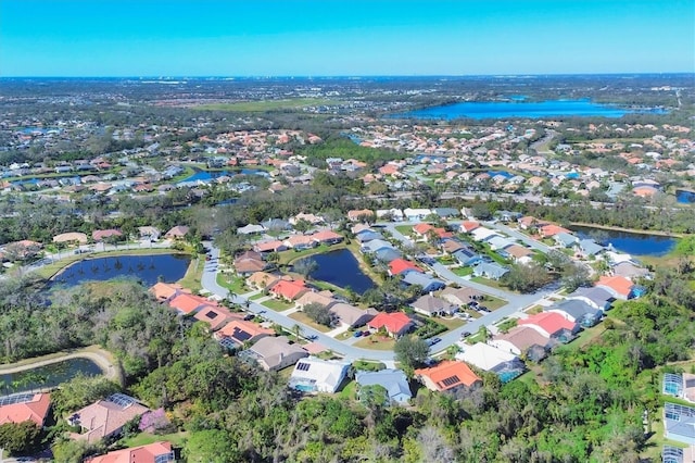 bird's eye view featuring a residential view and a water view