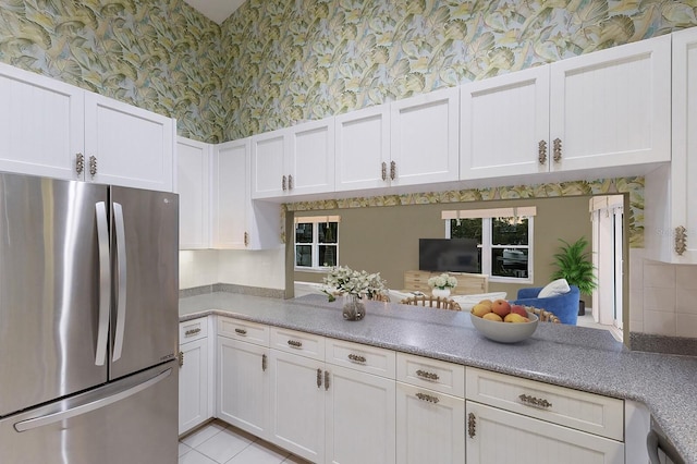 1528 43rd Avenue Dr W, Palmetto, FL 34221 - kitchen with white cabinets, freestanding refrigerator, a peninsula, and wallpapered walls