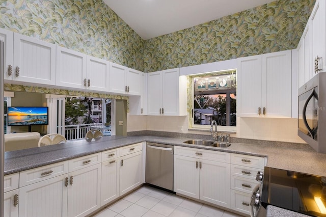 1528 43rd Avenue Dr W, Palmetto, FL 34221 - kitchen with tasteful backsplash, range with electric cooktop, a sink, wallpapered walls, and stainless steel dishwasher