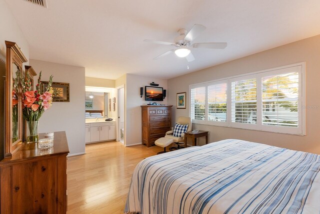 1528 43rd Avenue Dr W, Palmetto, FL 34221 - bedroom featuring light wood finished floors, baseboards, ensuite bath, and a ceiling fan