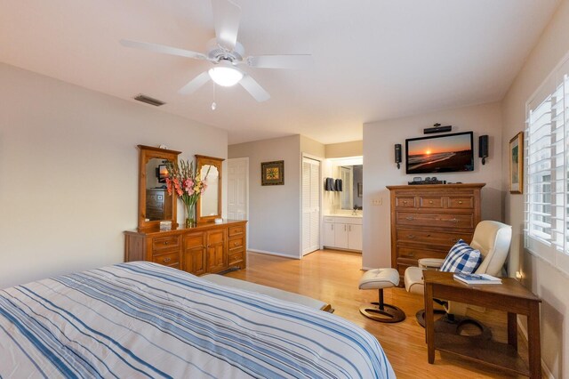 1528 43rd Avenue Dr W, Palmetto, FL 34221 - bedroom featuring a closet, ensuite bath, multiple windows, and light wood-type flooring