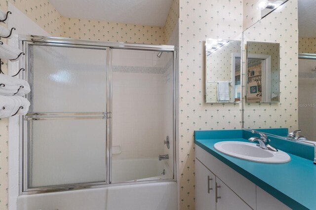 1528 43rd Avenue Dr W, Palmetto, FL 34221 - bathroom with combined bath / shower with glass door, vanity, and wallpapered walls
