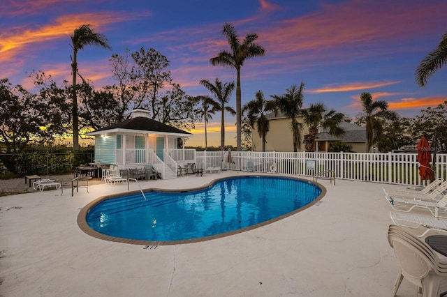 1528 43rd Avenue Dr W, Palmetto, FL 34221 - pool at dusk featuring a community pool, a patio area, and fence